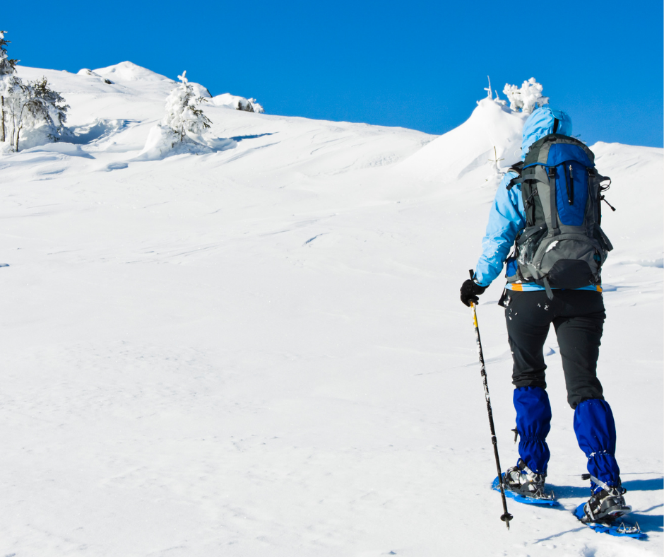 Woman snowshoeing through snow